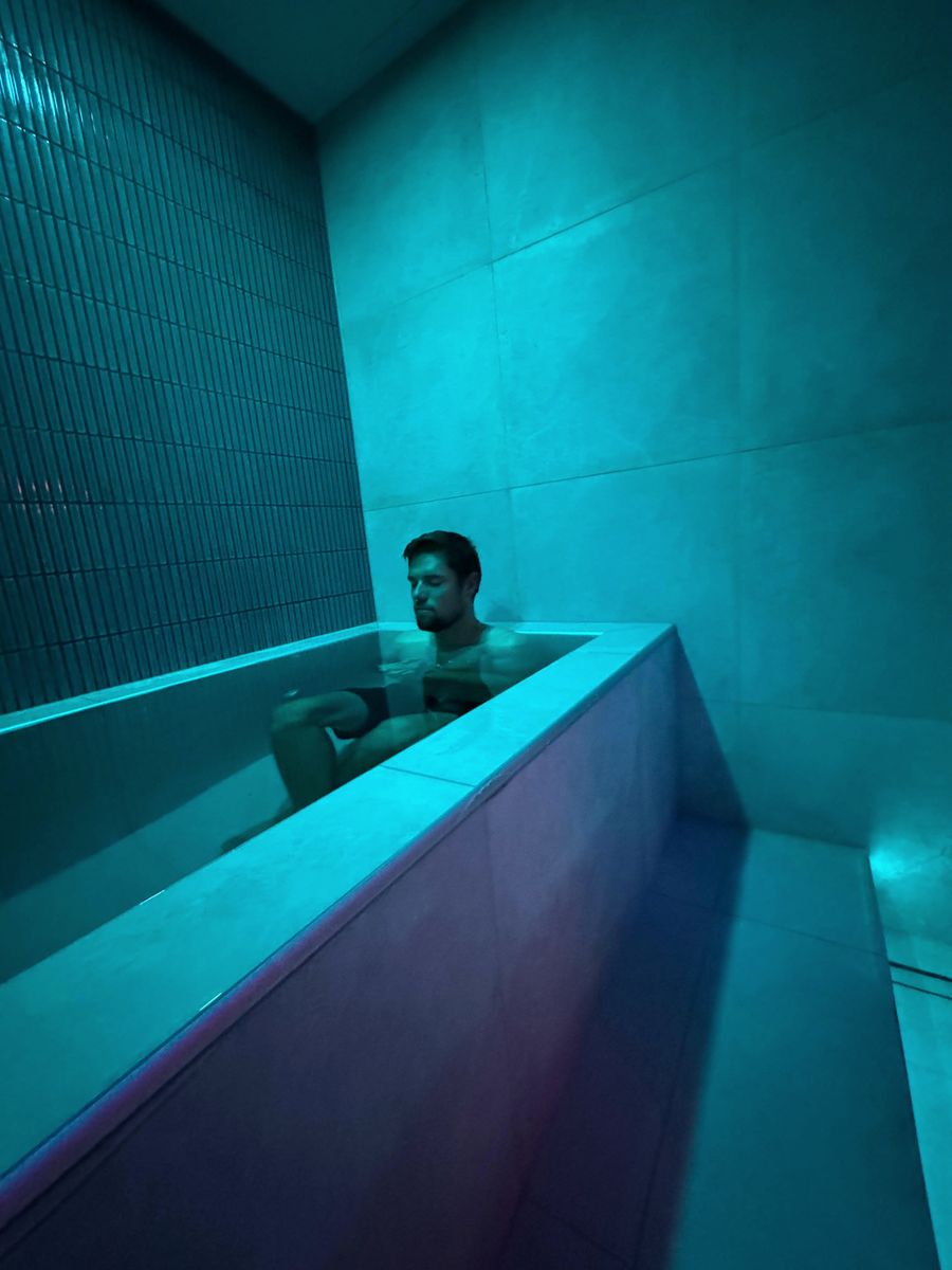 The lit cold plunge in a private contrast room at Renew
