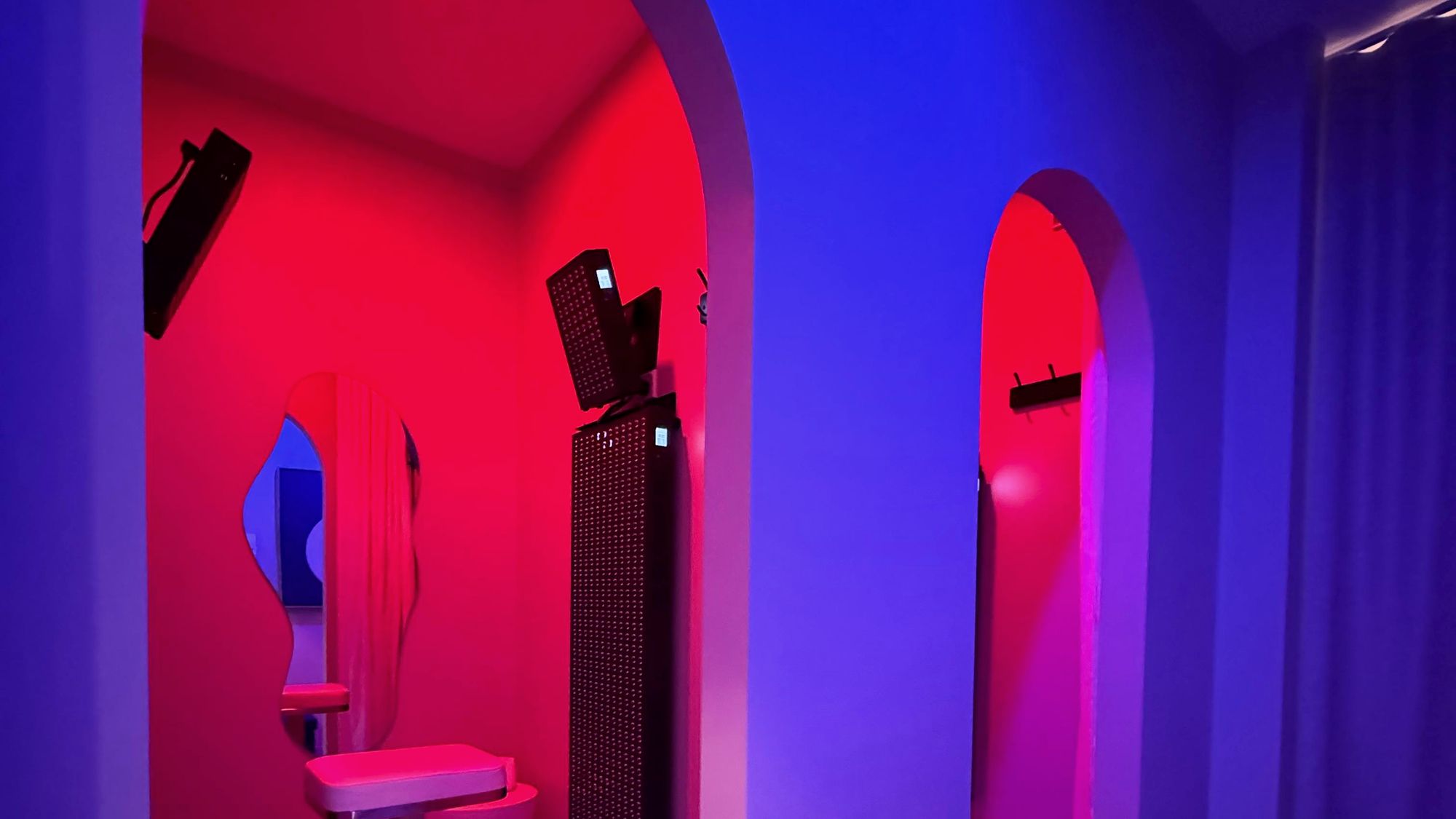 The red light room at Renew, the arched doorways lit deep red with an LED panel inside