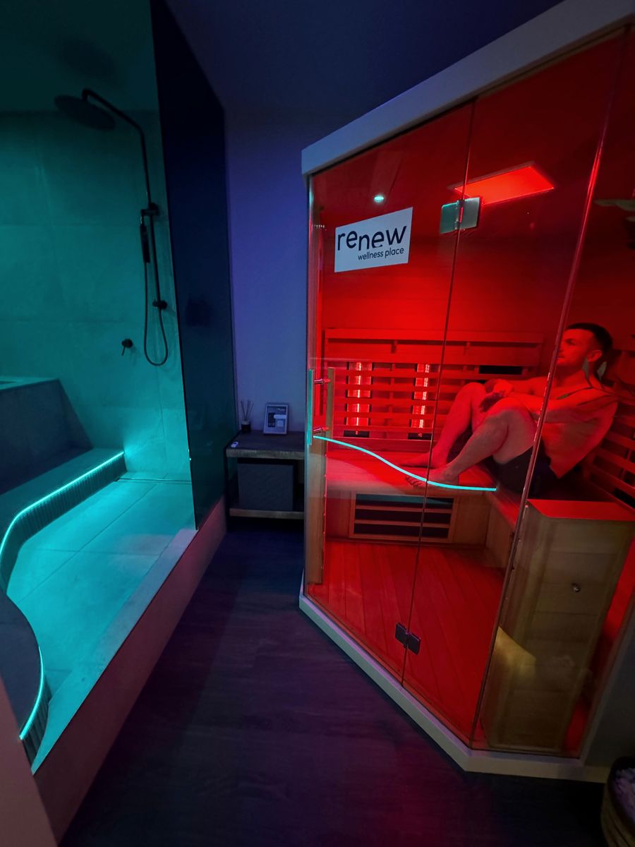 A private Renew room with the lit cold plunge on one side and the infrared sauna on the other