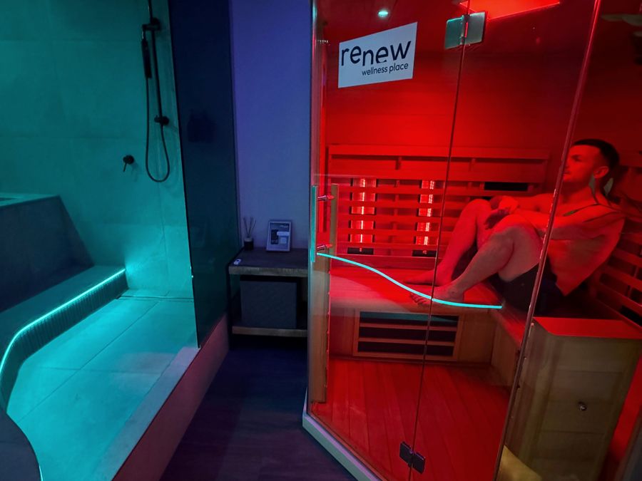 A private Renew room with the lit cold plunge on one side and the infrared sauna on the other